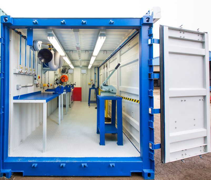 a blue and white container with a blue table and chairs